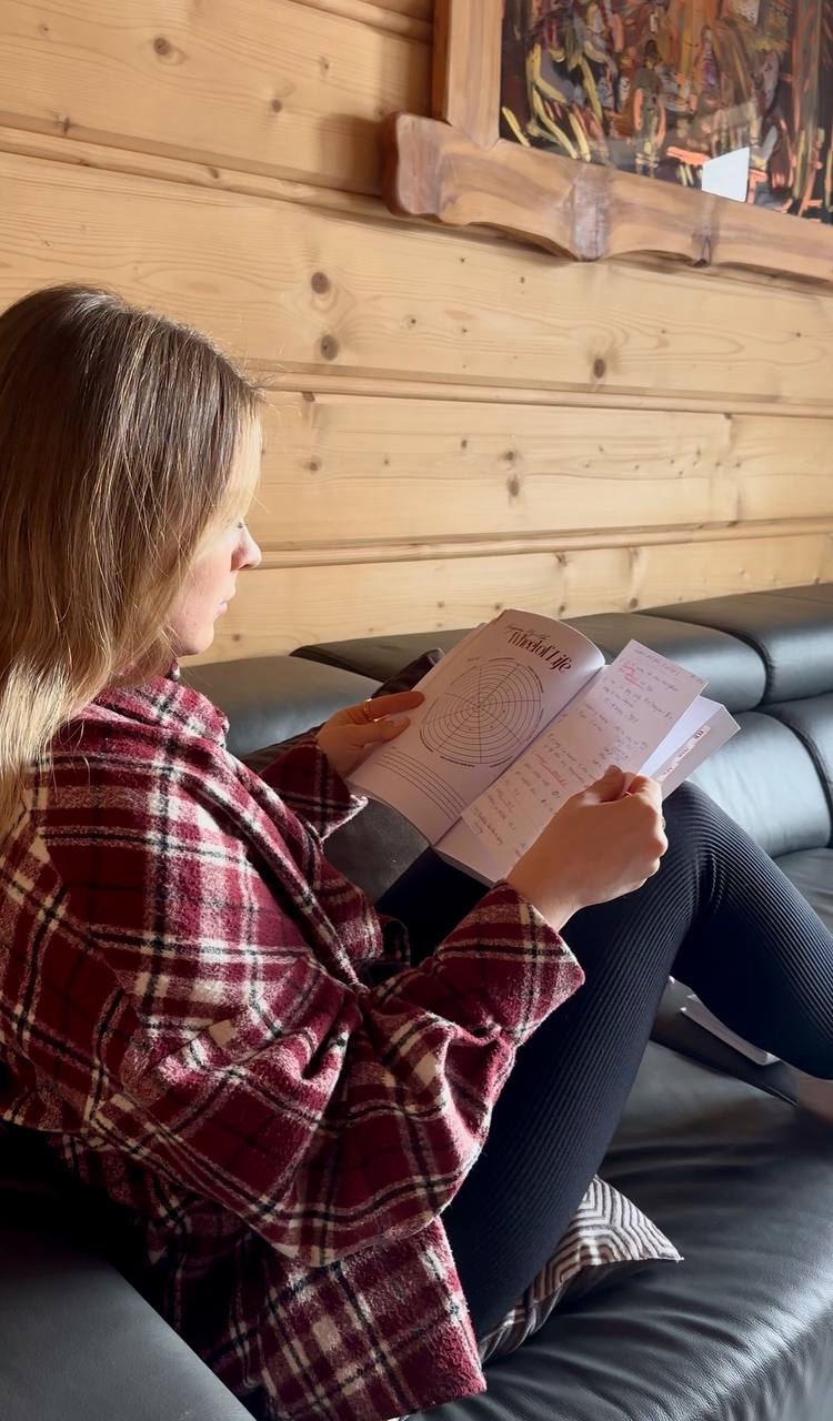A birthday journal open with a cup of coffee
